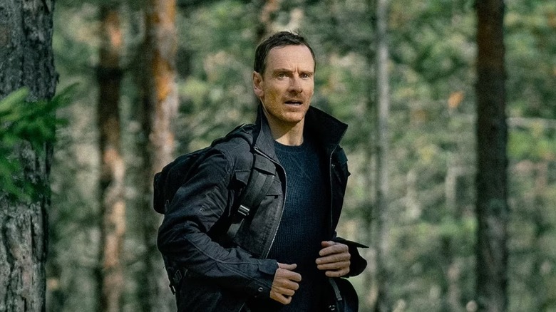 Martian (Michael Fassbender) runs through the woods on The Agency