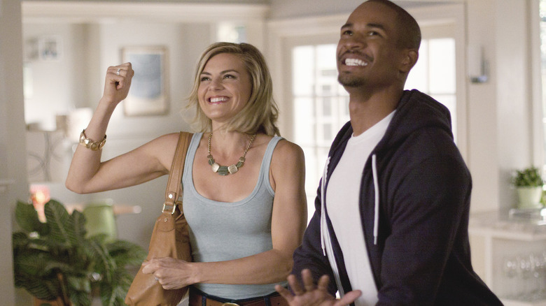 Jane (Eliza Coupe) and Brad (Damon Wayans, Jr.) react happily in Happy Endings