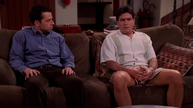 Alan (Jon Cryer) speaks to Charlie (Charlie Sheen) on the couch in Two and a Half Men