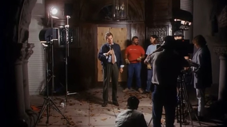 Morton Downey Jr. as Horton, filming an intro segment with a TV crew on Tales from the Crypt