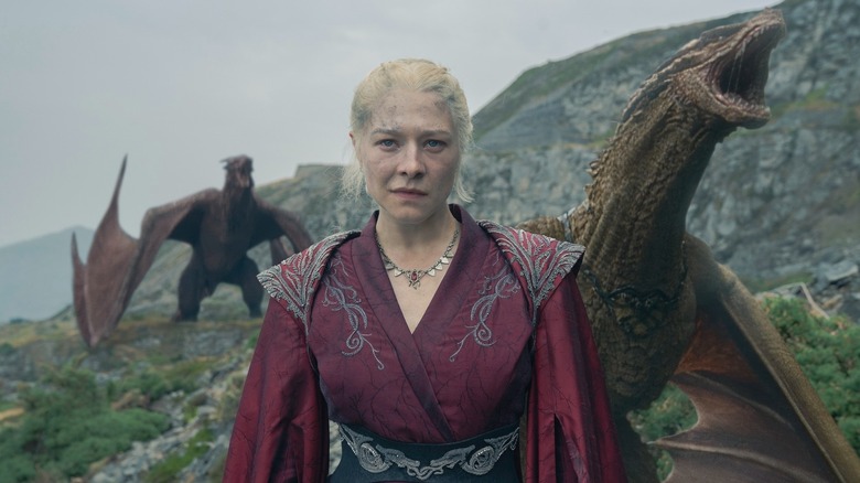 Emma D'Arcy as  Rhaenyra Targaryen standing in front of dragons in House of the Dragon