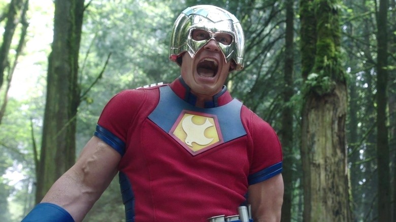 John Cena as Peacemaker in costume and screaming on Peacemaker