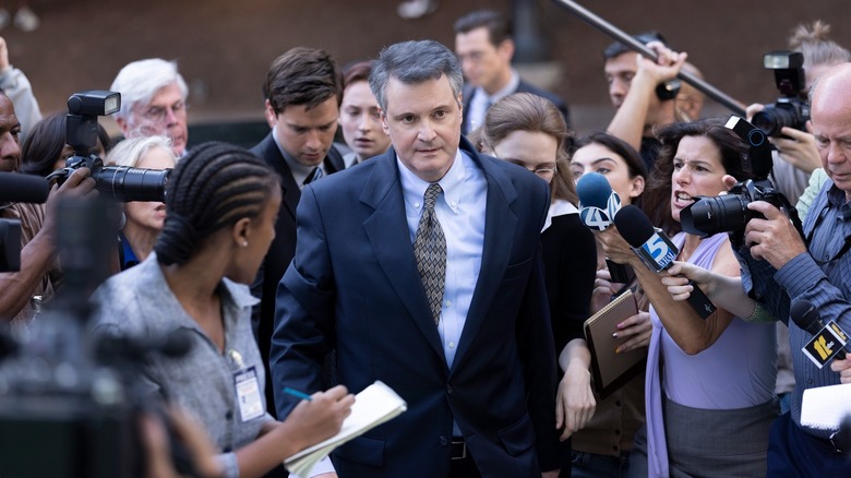 Colin Firth as Michael Peterson walking through a crowd in The Staircase