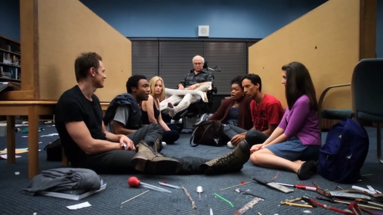 The study group sitting together on the floor on Community