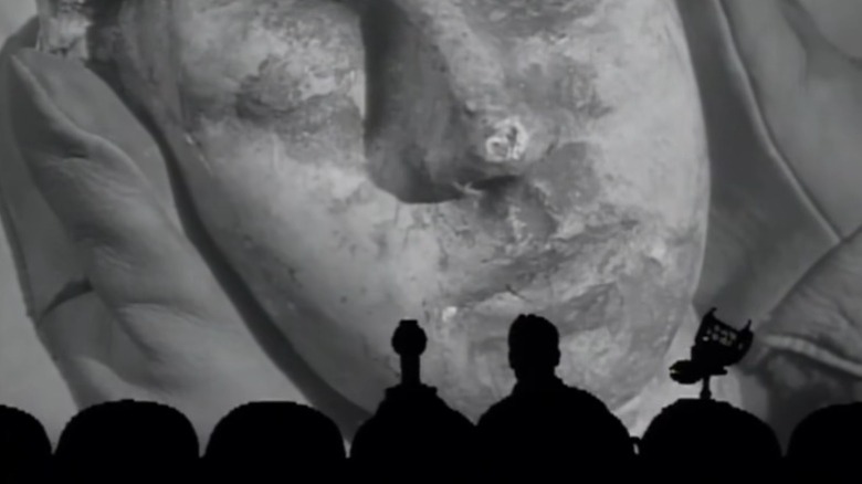 Tom Servo, Michael J. Nelson as Mike Nelson, and Crow T. Robot watching The Mole People on Mystery Science Theater 3000