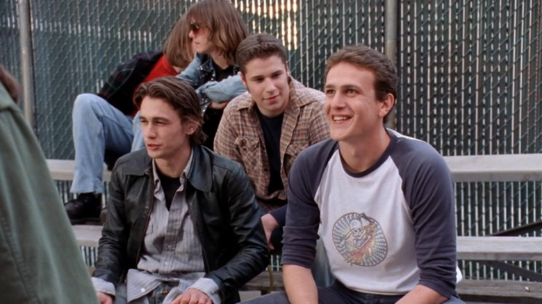 Daniel, Ken, and Nick sitting on benches on Freaks and Geeks