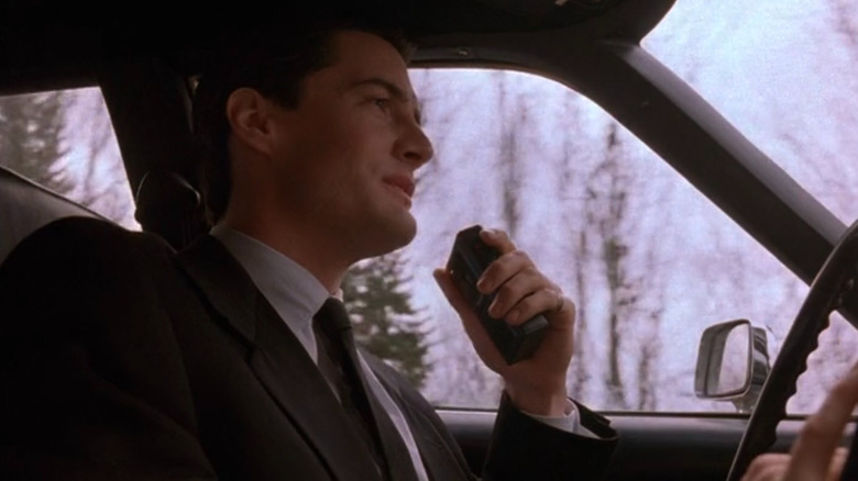 Dale Cooper (Kyle MacLachlan) speaking into recorder on Twin Peaks