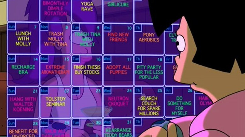 Amy looking at her holo-calendar while Leela sits behind it