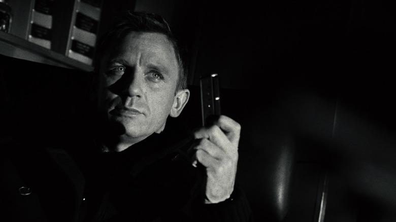 Daniel Craig showing off a pistol magazine.