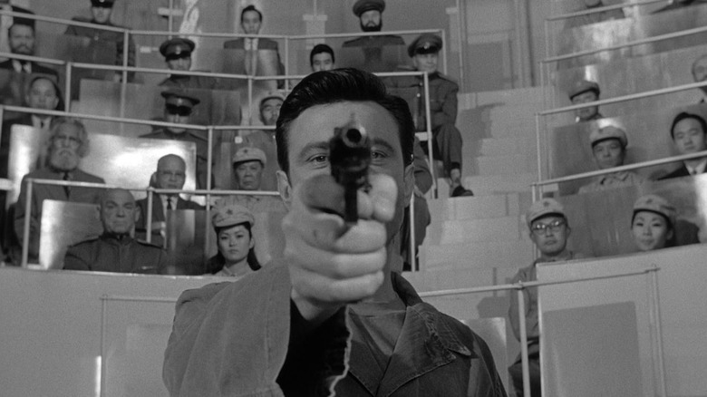 Laurence Harvey taking brainwashed aim