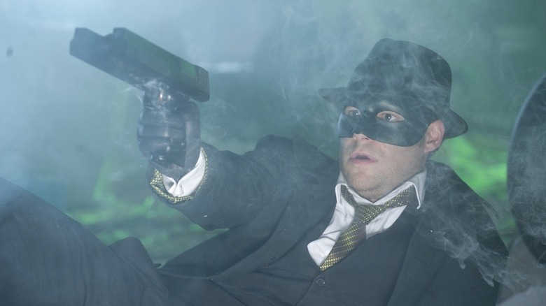 Seth Rogen aims gun in fog