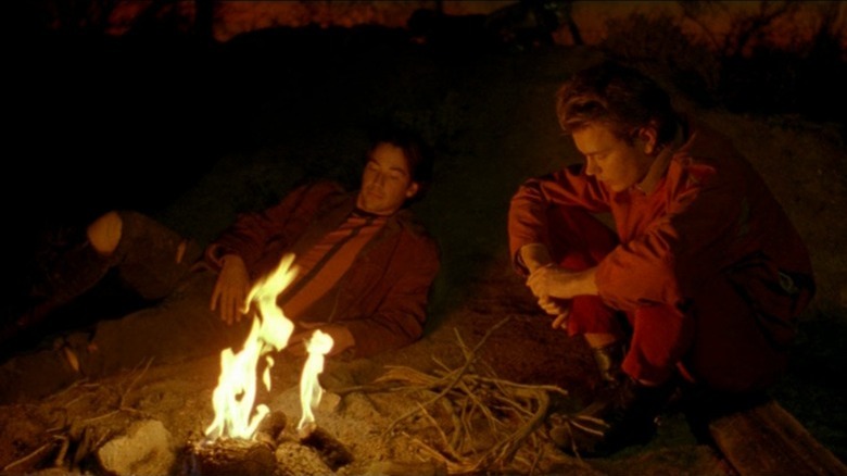 Mike and Scott sitting by a campfire