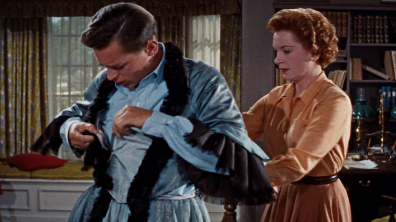 Deborah Kerr helping John Kerr into dress