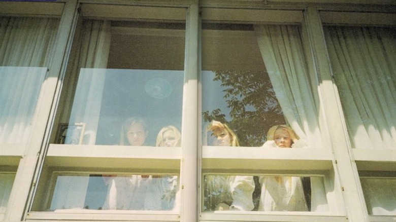 Sisters looking out windows