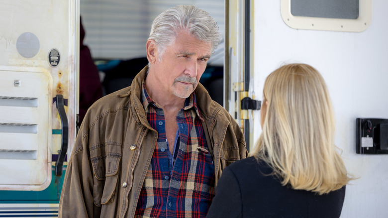 Jack (James Brolin) and Jackie (Mena Suvari) talking outside trailer in I'll Be Home for Christmas