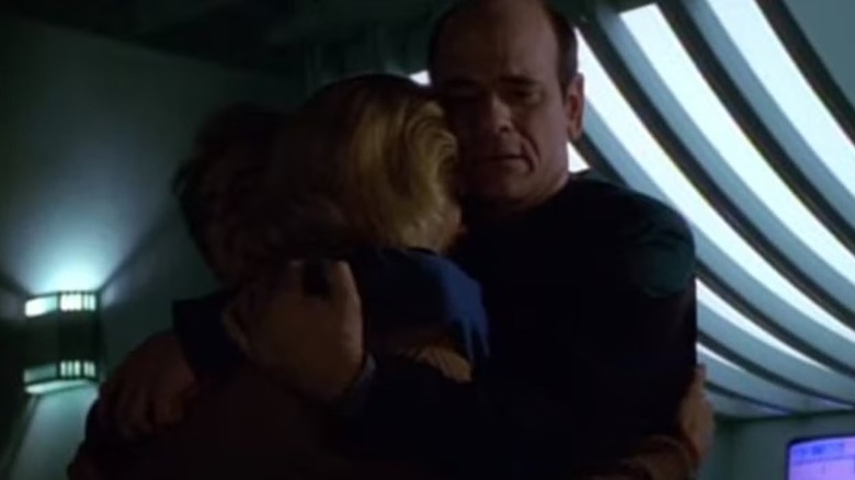 The Doctor (Robert Picardo) holds his crying family in Star Trek: Voyager