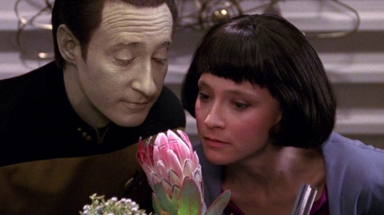 Data (Brent Spiner) smells a flower with Lal (Hallie Todd) in Star Trek: The Next Generation