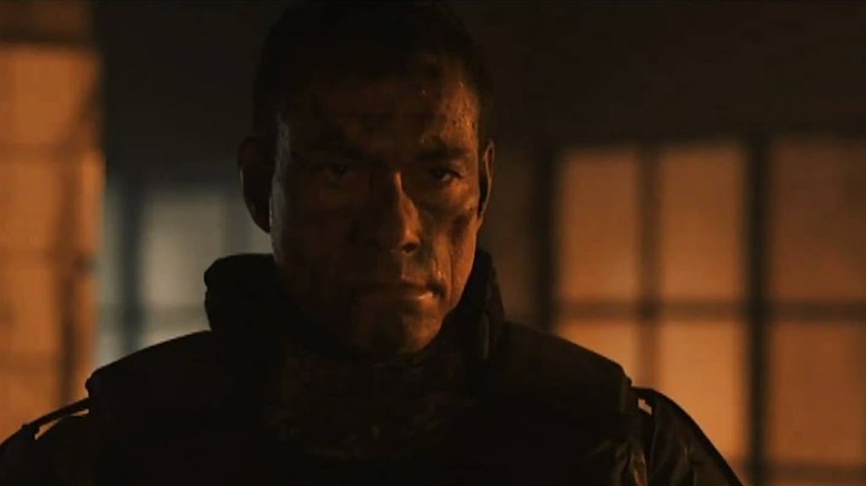 Jean-Claude Van Damme smoldering in the dark