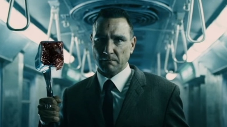 Vinnie Jones holding a bloody hammer