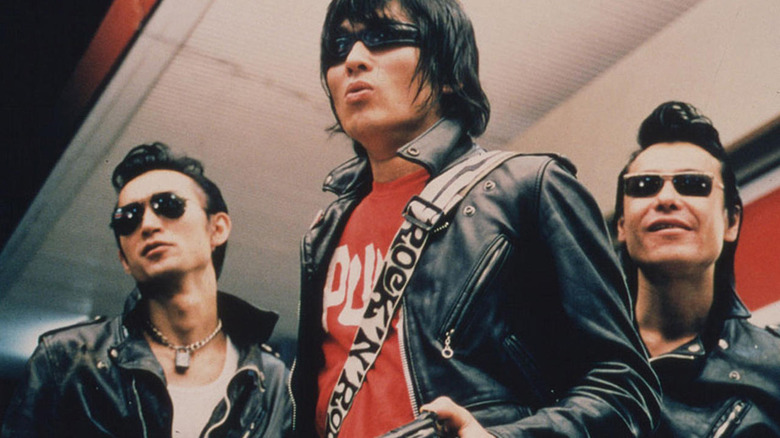 Guitar Wolf trio wears leather and sunglasses