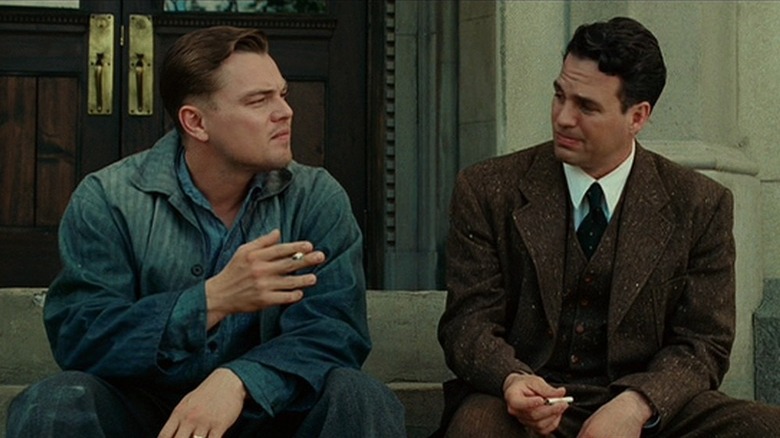 Leonardo DiCaprio's Teddy sitting with Mark Ruffalo's Chuck on the steps at the end of Shutter Island