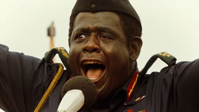 Idi Amin speaks into a microphone 