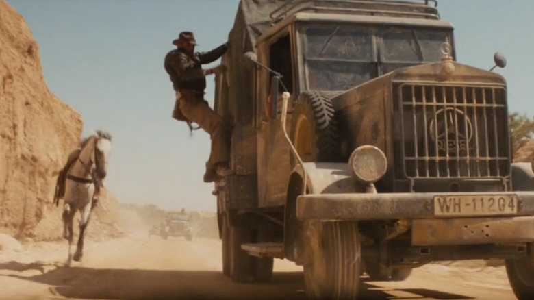 Indiana Jones jumping onto the side of a moving truck