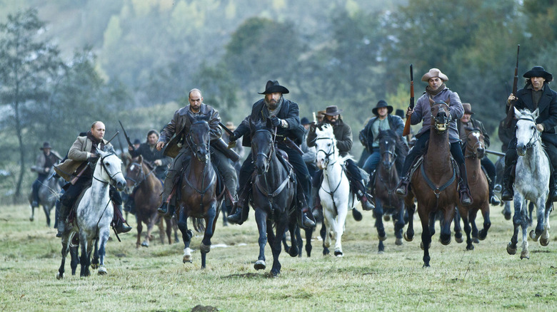 Men on horses charging in Hatfields & McCoys (2012)