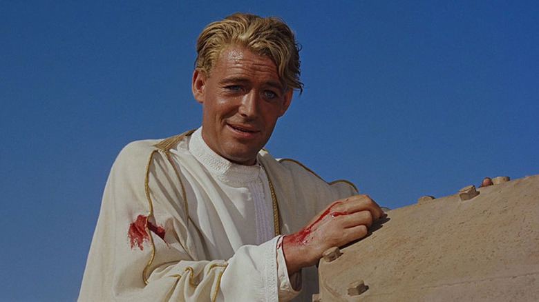 A wounded T.E. Lawrence (Peter O'Toole) rests against a tanker in Lawrence of Arabia