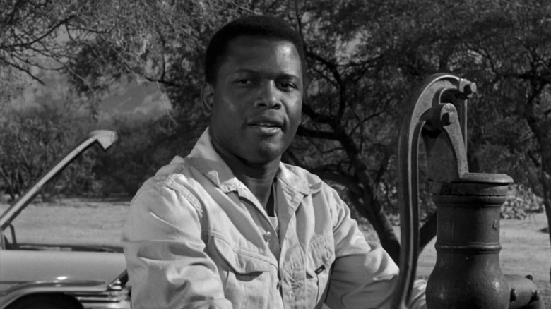 Homer Smith (Sidney Poitier) sits by a water pump in Lillies of the Field (1963)