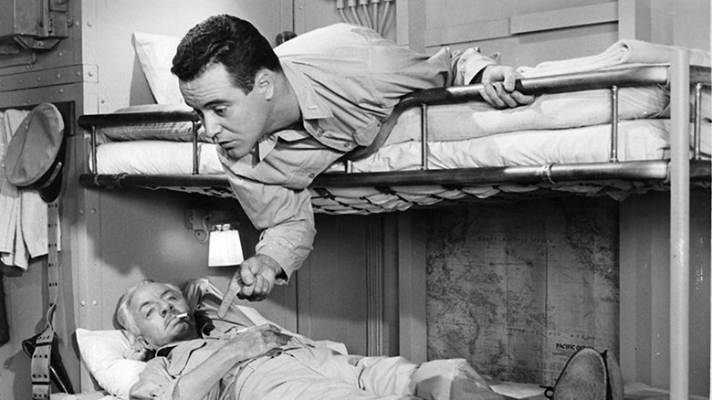 Jack Lemmon leans over bunk bed