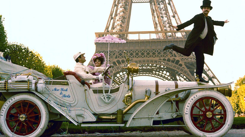 couple in jalopy by Eiffel Tower