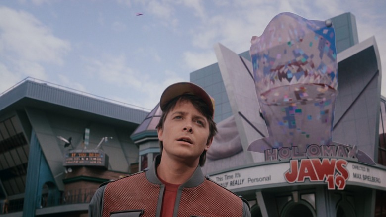 Marty standing in front of holographic Jaws in the future