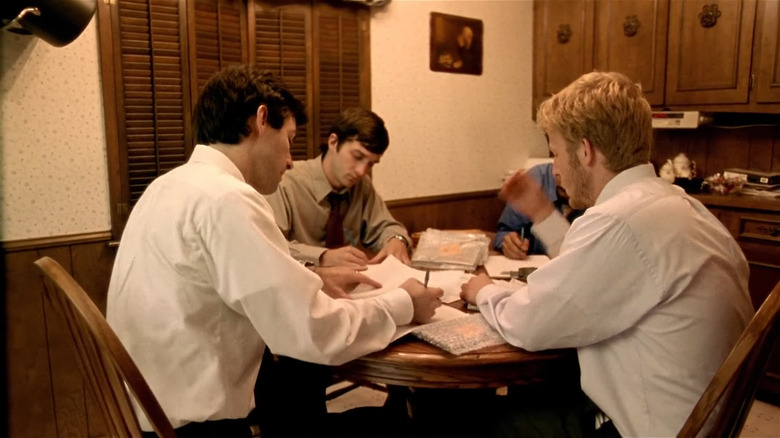 Scientists writing at kitchen table