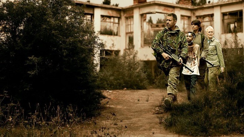 Melanie and her armed guard wander through deserted streets