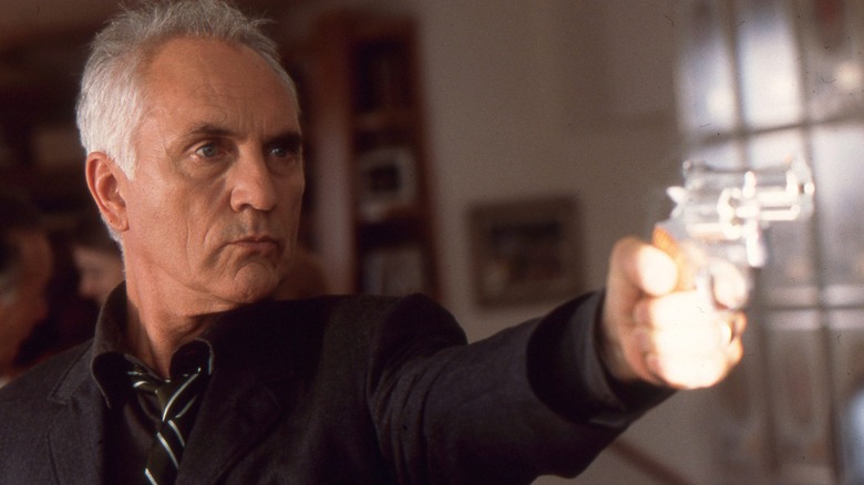 Terrence Stamp pointing gun