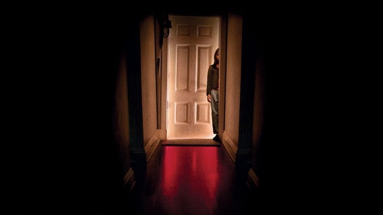 Dakota Fanning as Emily standing in the doorway on the poster for Hide and Seek