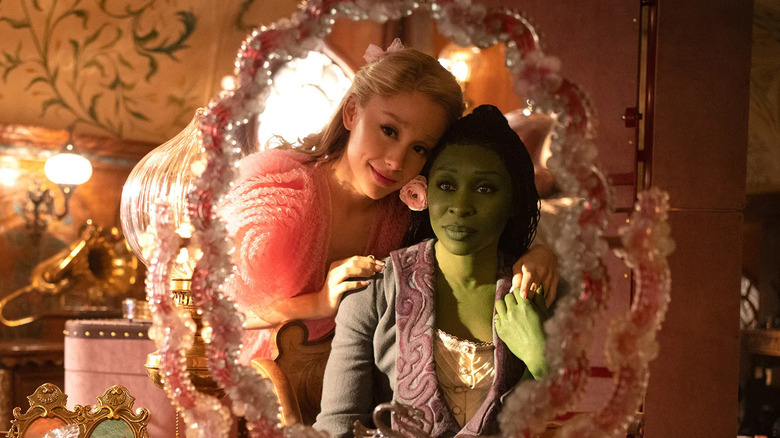 Ariana Grande and Cynthia Erivo look in the mirror in Wicked