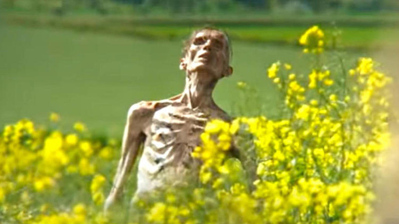 Angus Neill as Emaciated Zombie rises out of a field in 28 Years Later