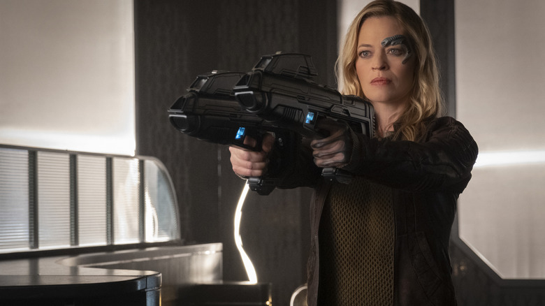 Jeri Ryan wielding two guns