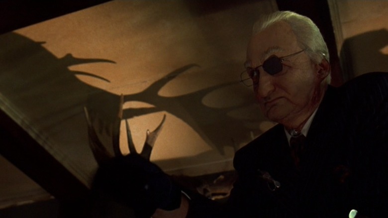 Robert Englund as Bill Gartley with the silhouette of a moose on the ceiling in The Mangler