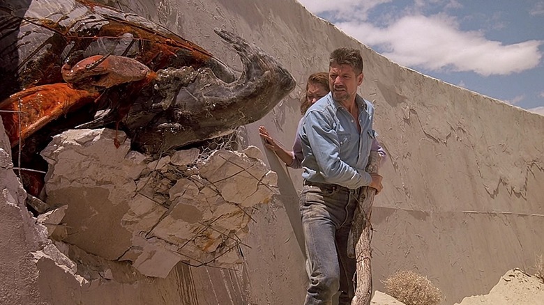 Fred Ward's Earl looking at a Graboid smashed and coming out of a wall in Tremors