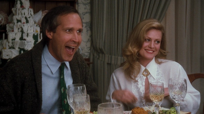 Chevy Chase as Clark Griswold and Beverly D'Angelo's Ellen sitting at the dinner table in National Lampoon's Christmas Vacation