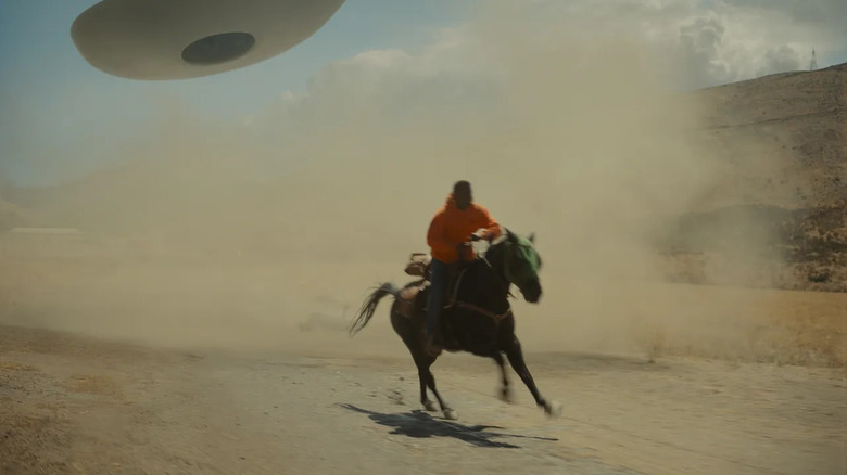 Spaceship chasing man on horse