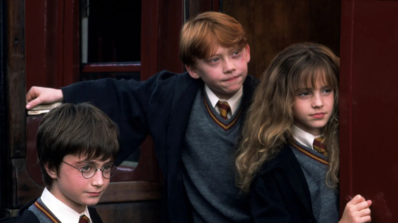 Harry, Ron and Hermione looking for clues in Harry Potter and the Sorcerer's Stone