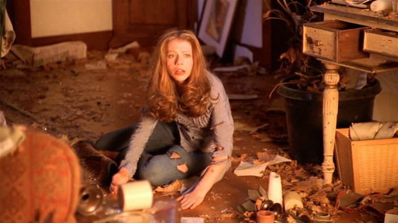 Dawn Summers looking disheveled on the floor of a destroyed room on Buffy the Vampire Slayer