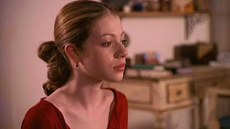 Dawn Summers wearing red sitting at the kitchen table in her and Buffy's house on Buffy the Vampire Slayer