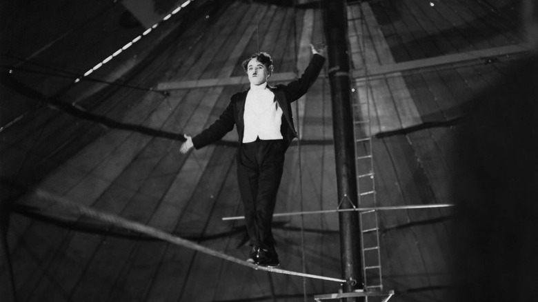 The Tramp wearing a tuxedo, tightrope walking in The Circus