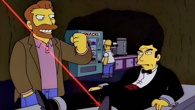 Hank Scorpio talks to Mr Bont as he sits on a table with a laser beam approaching in The Simpsons