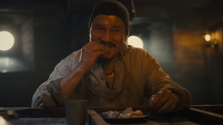 man eating bread and smiling